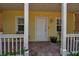 Inviting covered front porch with brick pavers and seating, perfect for relaxing at 508 Howard Ct, Sarasota, FL 34236