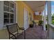 Charming front porch featuring brick pavers, comfortable seating, and a cozy atmosphere at 508 Howard Ct, Sarasota, FL 34236