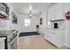 Bright, modern kitchen and dining area with stainless steel appliances, white cabinetry, and tile flooring at 508 Howard Ct, Sarasota, FL 34236