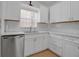 Updated kitchen with stainless steel appliances, white cabinetry, and tile backsplash at 508 Howard Ct, Sarasota, FL 34236