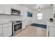 Open kitchen featuring new stainless steel appliances and adjacent dining area with a modern light fixture at 508 Howard Ct, Sarasota, FL 34236
