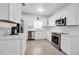 White kitchen featuring new stainless steel appliances and ample cabinet space at 508 Howard Ct, Sarasota, FL 34236