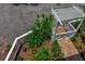 Aerial view of a meticulously landscaped yard featuring a pergola and diverse plants with vibrant greenery at 508 Howard Ct, Sarasota, FL 34236