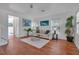 Cozy living room featuring hardwood floors, a white sofa, and access to other rooms at 508 Howard Ct, Sarasota, FL 34236