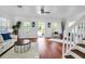 Inviting living room with hardwood floors, a white sofa, and a seamless indoor-outdoor flow at 508 Howard Ct, Sarasota, FL 34236