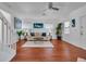 Bright living room featuring hardwood floors, white sofa and coastal-themed artwork at 508 Howard Ct, Sarasota, FL 34236