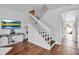 Well-lit staircase with hardwood floors and views into other rooms at 508 Howard Ct, Sarasota, FL 34236