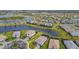 An expansive aerial view captures a Primary-planned community with homes and serene lakes at 5117 Marina Basin Ct, Bradenton, FL 34211