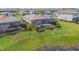 Aerial view of a landscaped backyard with a screened-in pool and lush greenery at 5117 Marina Basin Ct, Bradenton, FL 34211