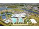 Aerial view of community clubhouse, pool, sports courts, parking and residences in planned community at 5117 Marina Basin Ct, Bradenton, FL 34211
