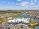 Aerial view of the community clubhouse, pool, playground, sports courts, parking, and nearby residences at 5117 Marina Basin Ct, Bradenton, FL 34211