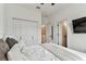 Well-lit bedroom featuring a ceiling fan, a comfortable bed, and ensuite bathroom at 5117 Marina Basin Ct, Bradenton, FL 34211