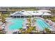 Poolside view of the community clubhouse, recreational pool, lap pool and lounge chairs with palm trees at 5117 Marina Basin Ct, Bradenton, FL 34211