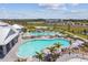 Aerial view of a resort-style pool area with palm trees and plenty of seating for residents at 5117 Marina Basin Ct, Bradenton, FL 34211