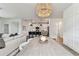 Bright dining area with a modern table, an open view to the kitchen and comfortable sectional in the living room at 5117 Marina Basin Ct, Bradenton, FL 34211