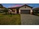 Charming single-story home with a well-manicured lawn and paved driveway at 5117 Marina Basin Ct, Bradenton, FL 34211
