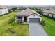 Aerial view of a charming single-story home with a well-manicured lawn and paved driveway at 5117 Marina Basin Ct, Bradenton, FL 34211