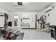 A clean garage featuring a home gym, organized storage, and an open door to the laundry room at 5117 Marina Basin Ct, Bradenton, FL 34211