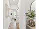 Bright hallway with wood-look flooring, leading to a bedroom at 5117 Marina Basin Ct, Bradenton, FL 34211