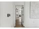 Hallway provides a peek into the primary bedroom suite, showcasing clean lines and modern design at 5117 Marina Basin Ct, Bradenton, FL 34211