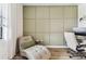 Comfortable home office with a chaise lounge, decorative wall paneling, and functional desk area at 5117 Marina Basin Ct, Bradenton, FL 34211