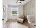 Bright home office featuring a window with blinds, a comfortable chaise lounge, and a functional desk area at 5117 Marina Basin Ct, Bradenton, FL 34211