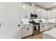 Bright eat-in kitchen with white cabinets, stainless steel appliances, and gas range at 5117 Marina Basin Ct, Bradenton, FL 34211