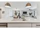 Stylish kitchen island overlooking dining area and living room with fireplace at 5117 Marina Basin Ct, Bradenton, FL 34211