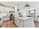 Bright kitchen with white cabinets, stainless steel appliances, and large island at 5117 Marina Basin Ct, Bradenton, FL 34211