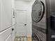Modern laundry closet featuring a stacked washer and dryer unit for space-saving convenience at 5117 Marina Basin Ct, Bradenton, FL 34211
