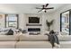 Bright living room featuring a modern fireplace, TV, and a comfortable white sectional sofa at 5117 Marina Basin Ct, Bradenton, FL 34211