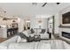 Spacious living room featuring an open layout with a kitchen, fireplace, and comfortable sectional seating at 5117 Marina Basin Ct, Bradenton, FL 34211