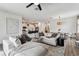 Open-concept living room with a large sectional sofa, dining area, and a view of the modern kitchen at 5117 Marina Basin Ct, Bradenton, FL 34211