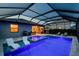 Illuminated pool with spa, poolside loungers, and an outdoor kitchen for evening gatherings at 5117 Marina Basin Ct, Bradenton, FL 34211