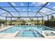 Screened-in pool and spa overlooking the water create a relaxing backyard oasis at 5117 Marina Basin Ct, Bradenton, FL 34211