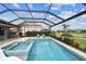 Stunning screened pool with a spa and lounge chairs, set against a picturesque landscape at 5117 Marina Basin Ct, Bradenton, FL 34211