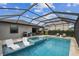 Beautiful screened pool with a spa, sun loungers, and covered patio, perfect for enjoying outdoor living at 5117 Marina Basin Ct, Bradenton, FL 34211