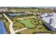 View of the community putting green, tennis courts, and surrounding landscaping at 5117 Marina Basin Ct, Bradenton, FL 34211