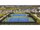 View of the community tennis courts with dark fencing for players' privacy and tall lights for nighttime play at 5117 Marina Basin Ct, Bradenton, FL 34211