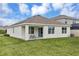 The home's backyard features a small patio, well-maintained lawn, and clean exterior walls at 5121 Sultana Cv, Bradenton, FL 34211