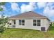 The home has a backyard with healthy grass, a small covered patio and a view of neighboring houses at 5121 Sultana Cv, Bradenton, FL 34211