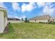 A spacious backyard with a well-maintained lawn, fence, and an enclosed patio at 5121 Sultana Cv, Bradenton, FL 34211