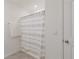 Bathroom featuring a shower with striped curtain, towel rack and tile flooring at 5121 Sultana Cv, Bradenton, FL 34211