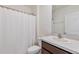 Cozy bathroom featuring a shower-tub combination, white shower curtain, and modern sink with neutral countertop at 5121 Sultana Cv, Bradenton, FL 34211