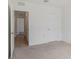 Spacious bedroom with neutral carpet and access to additional rooms at 5121 Sultana Cv, Bradenton, FL 34211