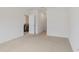 Bright bedroom with neutral carpet and an open doorway to the kitchen at 5121 Sultana Cv, Bradenton, FL 34211