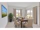 Formal dining room featuring a wooden table set for six, large windows, and an indoor plant at 5121 Sultana Cv, Bradenton, FL 34211
