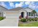 Charming single-story home featuring a two-car garage, well-maintained landscaping, and a welcoming front entrance at 5121 Sultana Cv, Bradenton, FL 34211