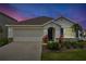 Charming single-story home featuring a two-car garage, well-maintained landscaping, and a welcoming front entrance at 5121 Sultana Cv, Bradenton, FL 34211
