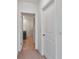 Hallway view with doors leading to the bathroom and other rooms at 5121 Sultana Cv, Bradenton, FL 34211